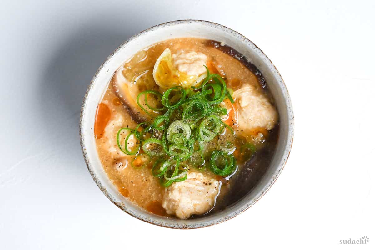 harusame soup with chicken meatballs in a cream bowl on a white background