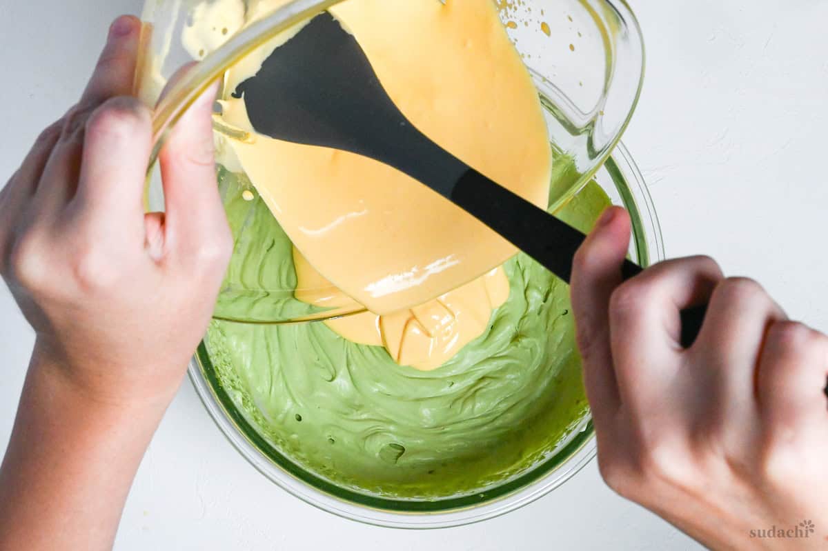 pouring egg mixture into matcha mascarpone cream mixture