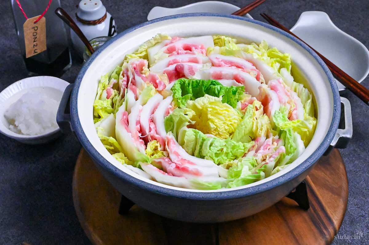 Japanese Mille Feuille Nabe (Pork and Napa Cabbage Hot Pot) in a gray pot on a dark gray background