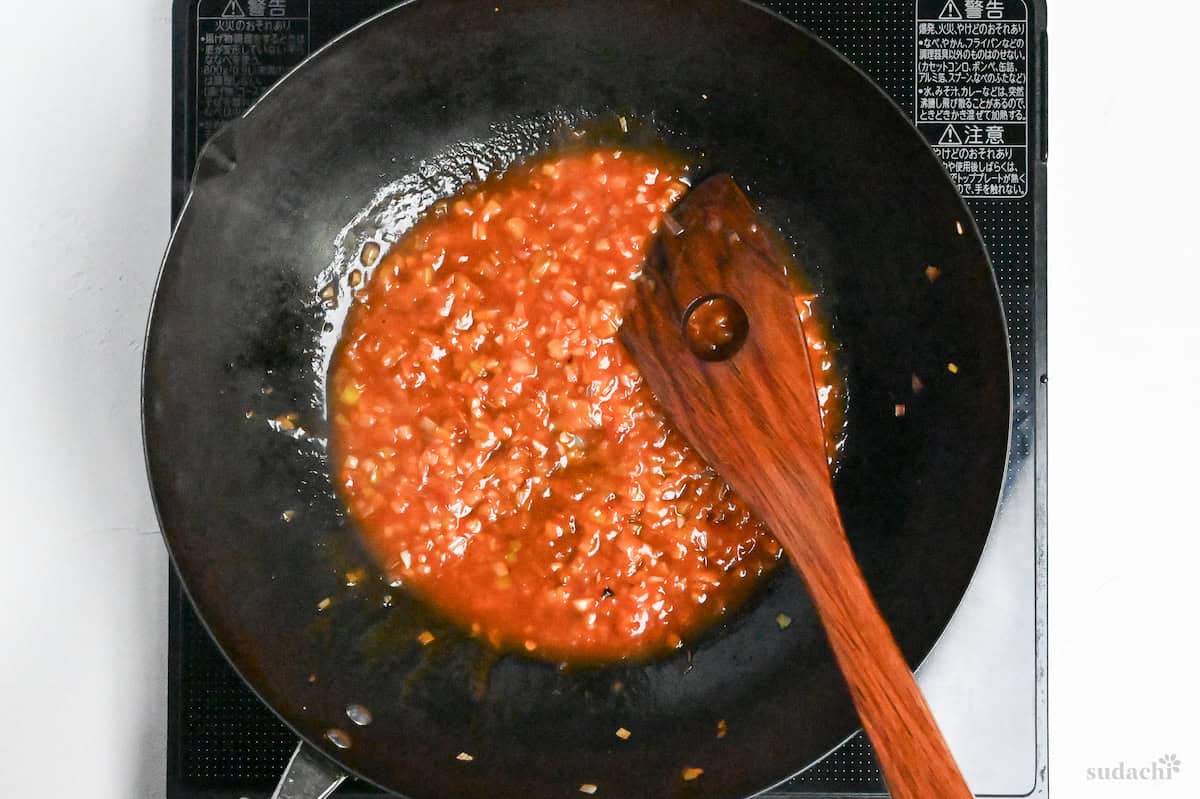 simmering tori chili sauce in a wok on the stove