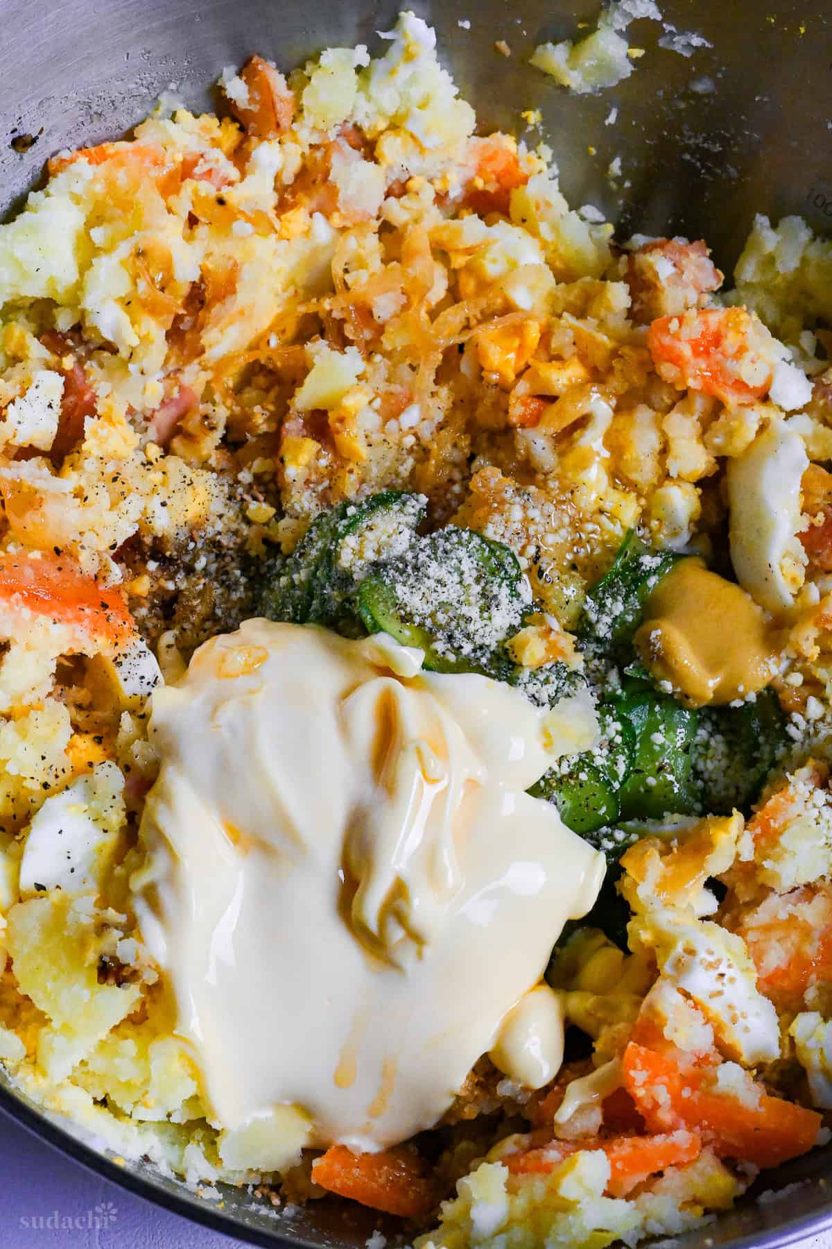 close up of Japanese izakaya style potato salad ingredients in a bowl ready to be mixed together