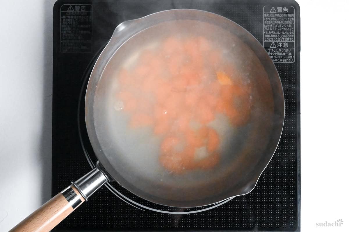 cut carrots in a pot of water on the stove