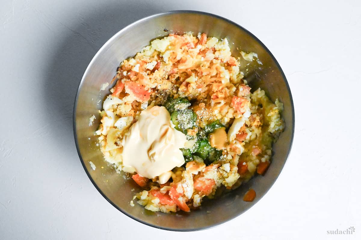 Japanese izakaya style potato salad ingredients in a mixing bowl ready to be mixed together