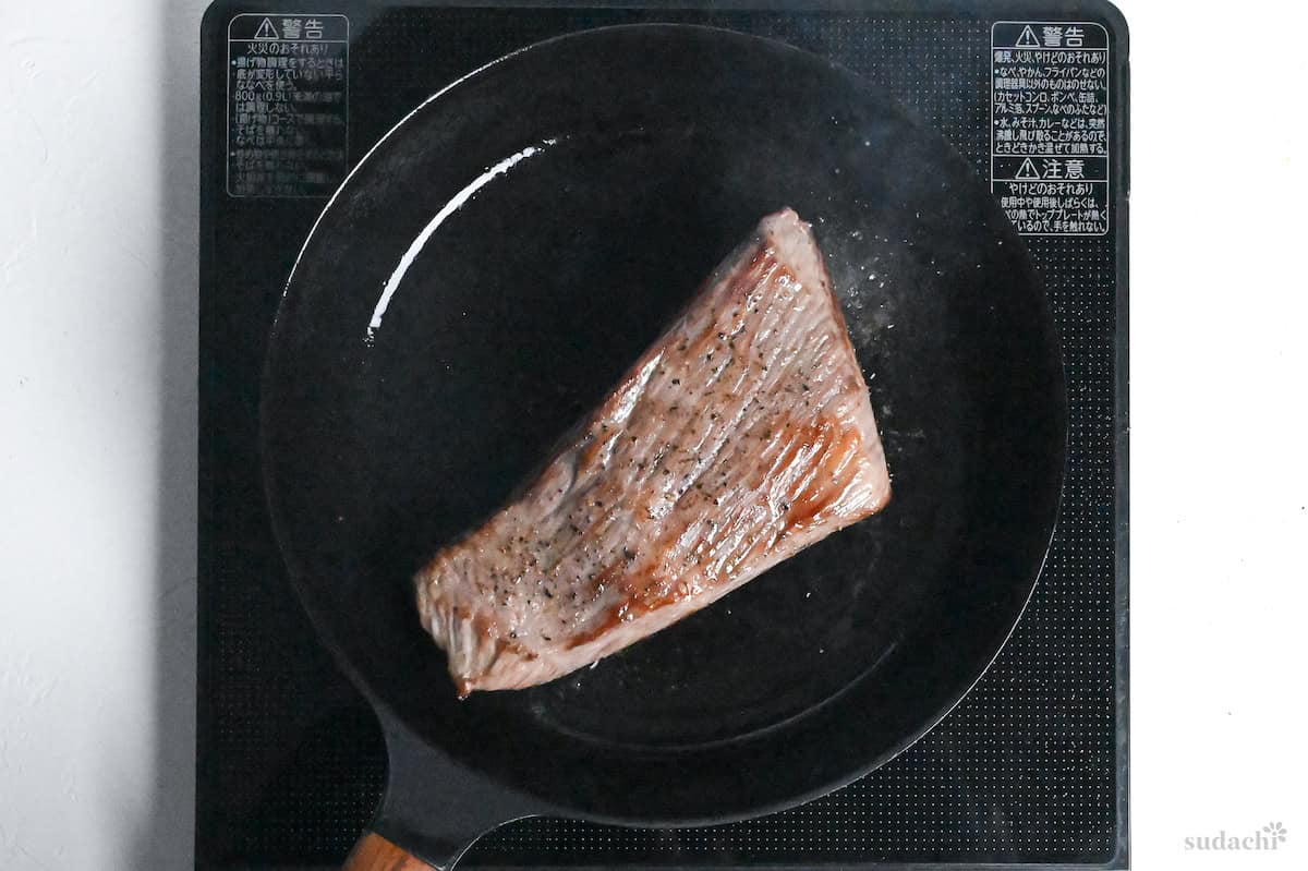 Seared beef round in a frying pan on the stove