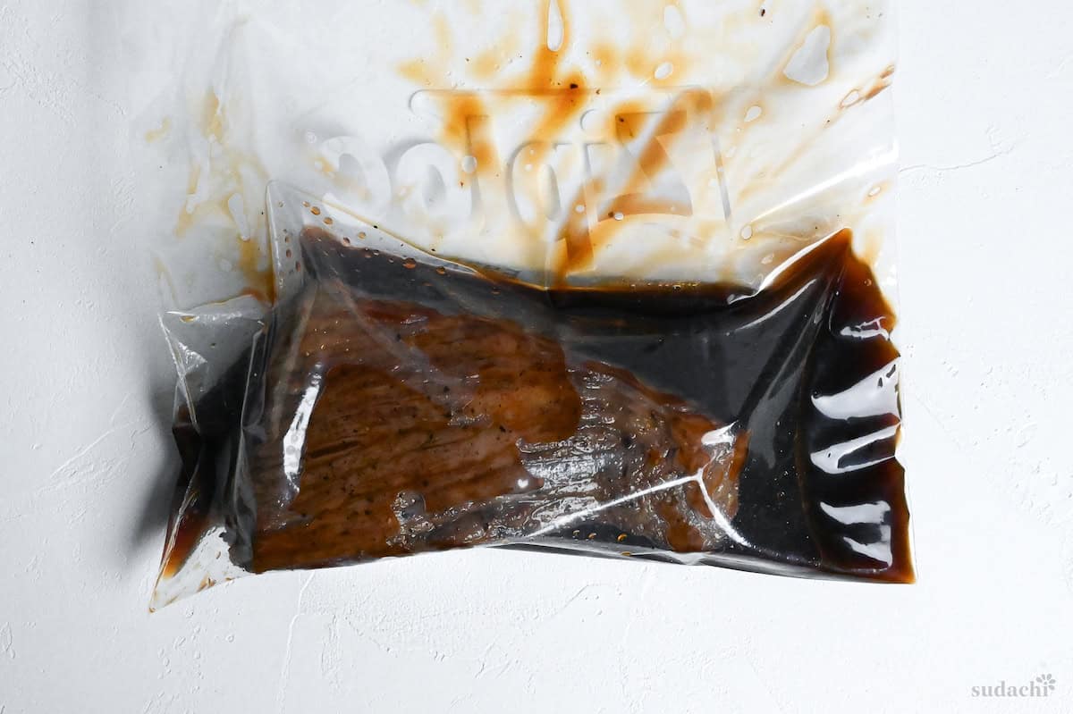 Japanese-style roast beef marinating in sauce in a sealable freezer bag