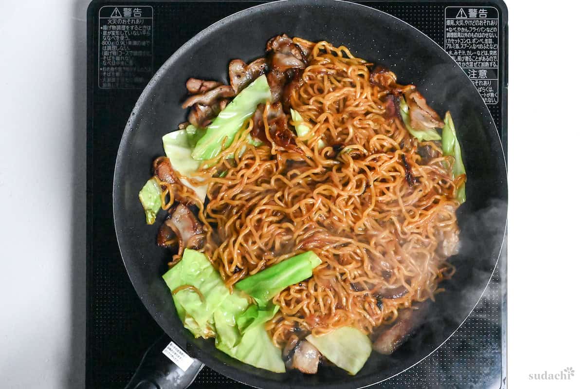 authentic Japanese yakisoba frying in a pan on the stove