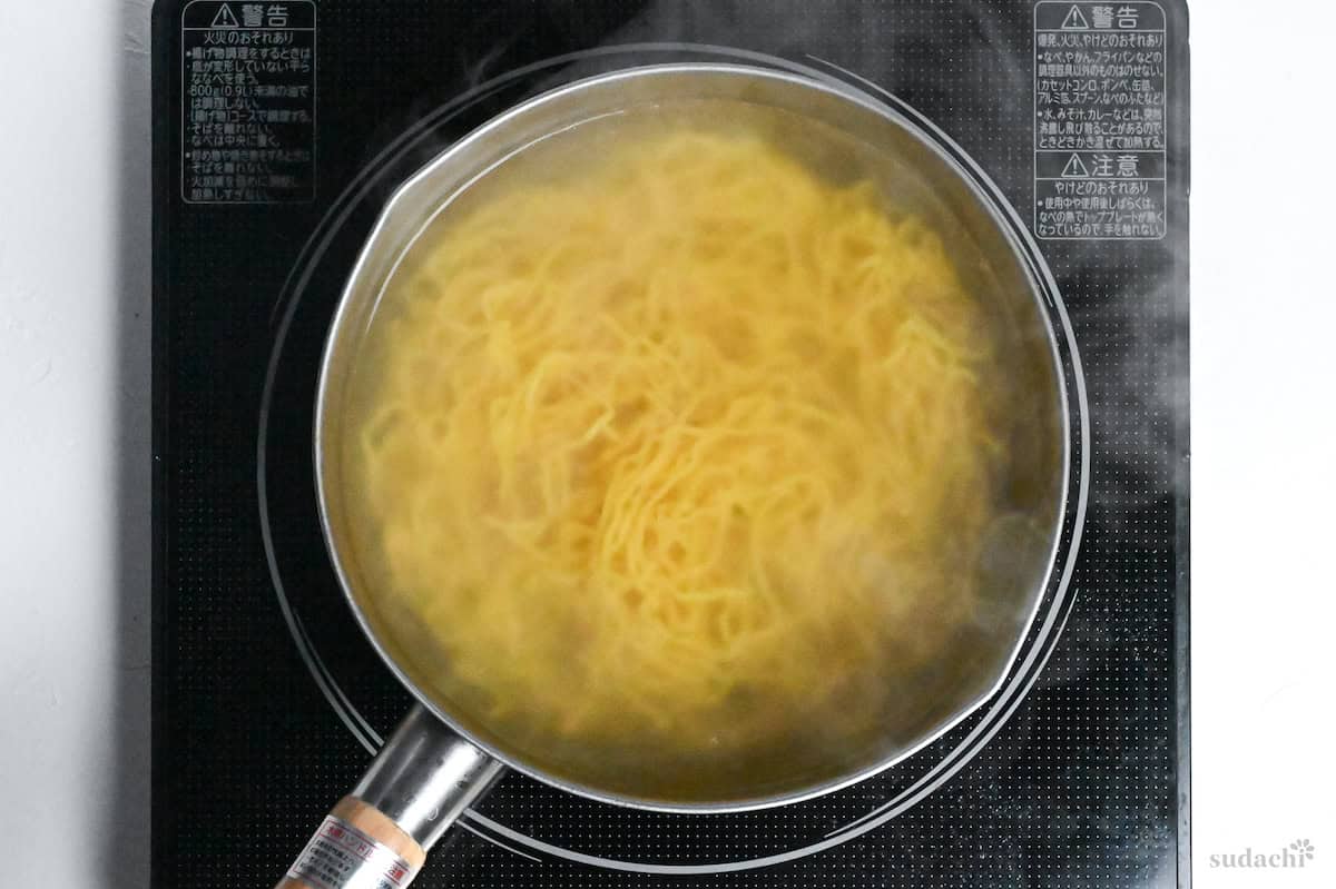 boiling ramen noodles in a pot of boiling water on the stove