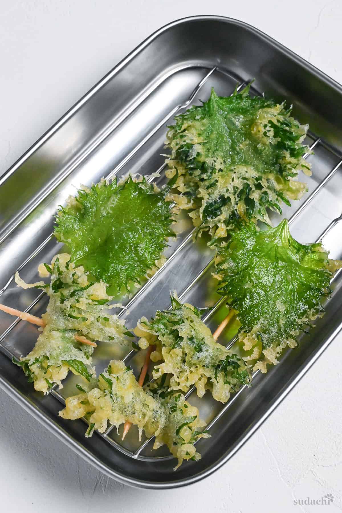 3 types of ooba tempura (shiso/Perilla leaf) on a wire rack to drain off excess oil