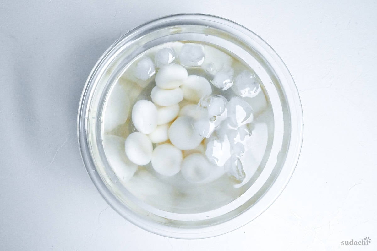 shiratama dango chilling in a glass bowl of ice water