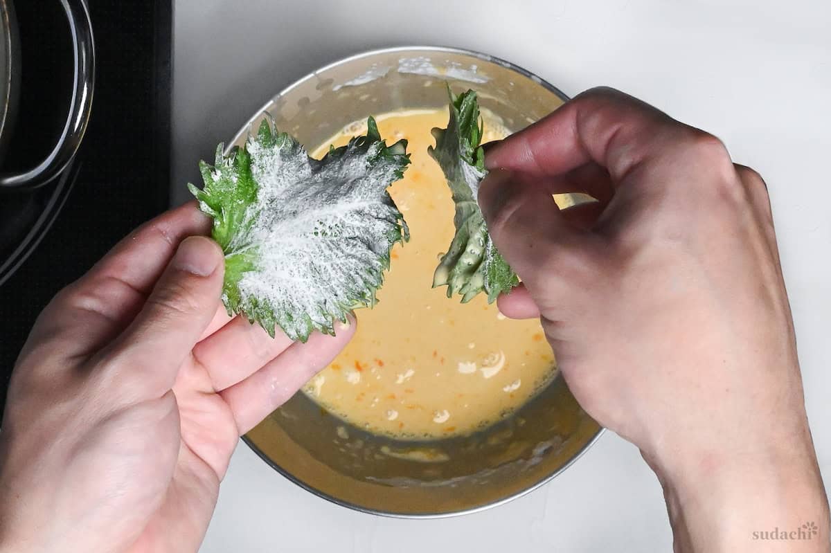 sticking two perilla leaves together using tempura batter to make stacked ooba tempura