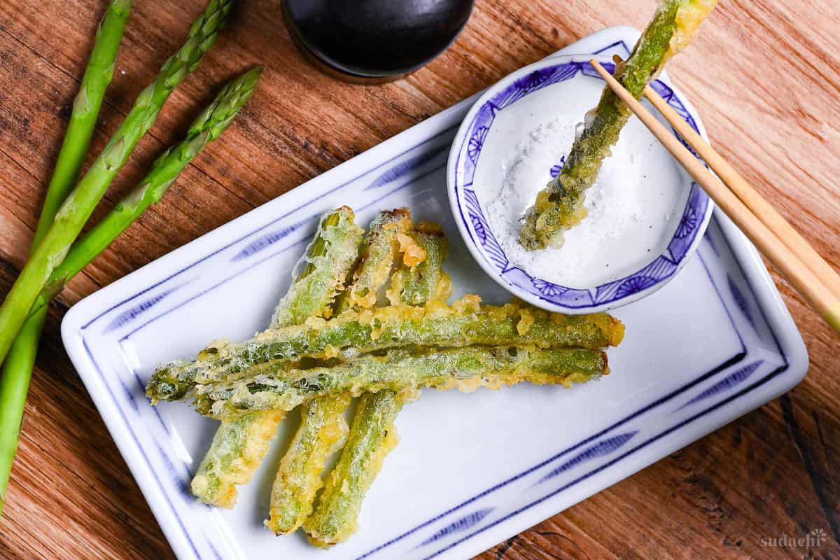 dipping asparagus tempura in salt