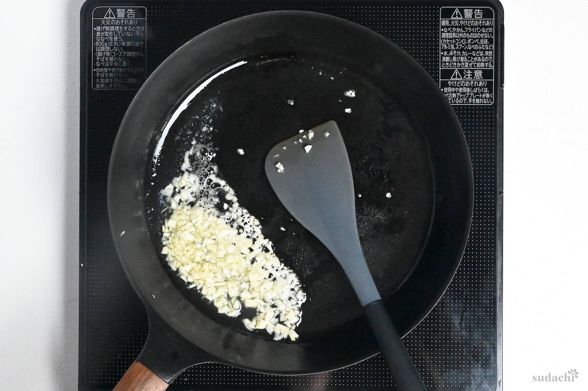 garlic frying in oil in a frying pan