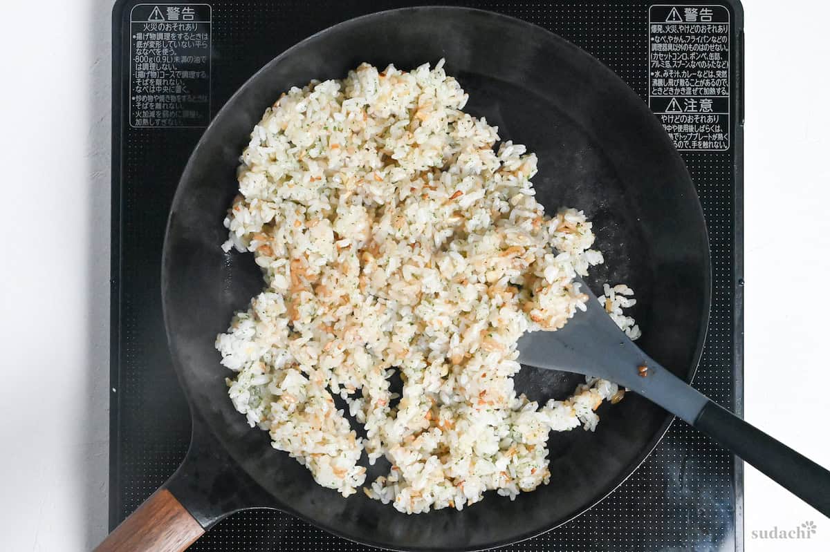 garlic fried rice in a frying pan on the stove top