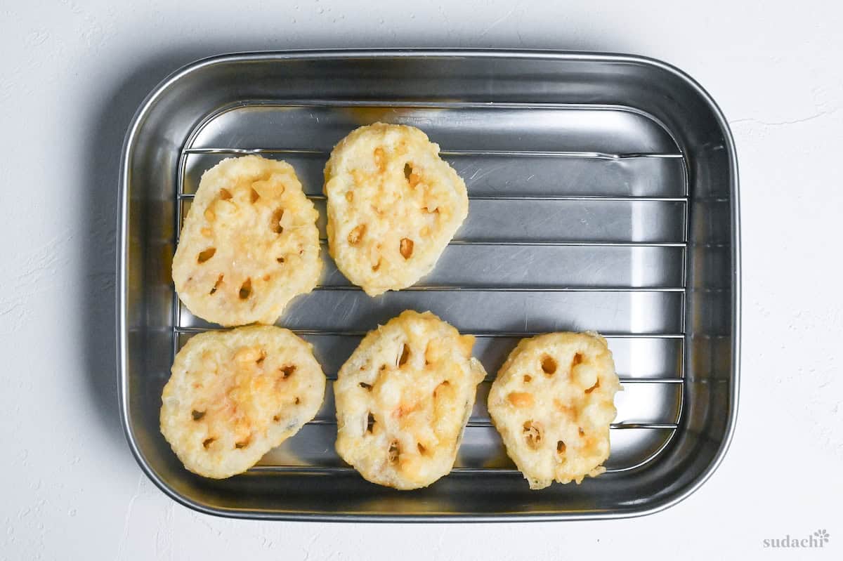 renkon no tempura (lotus root) draining on a wire rack