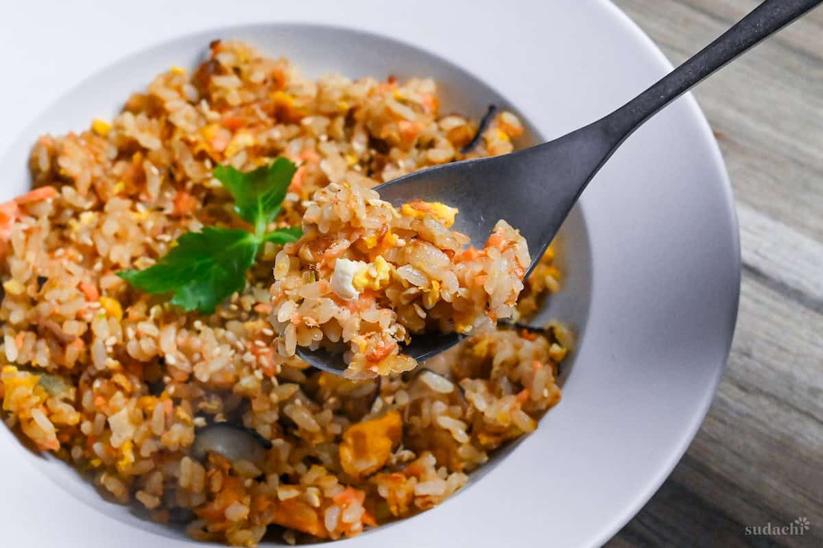 Salmon fried rice on a silver spoon