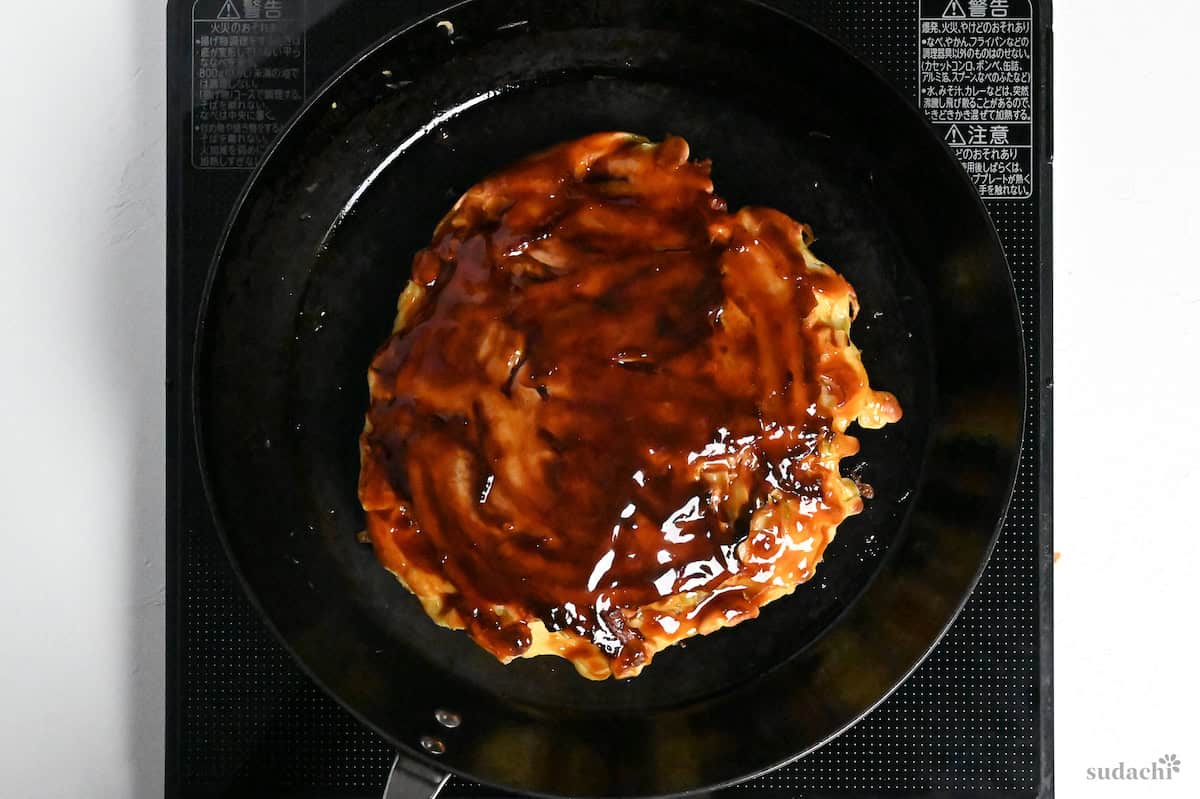 okonomiyaki topped with homemade okonomiyaki sauce