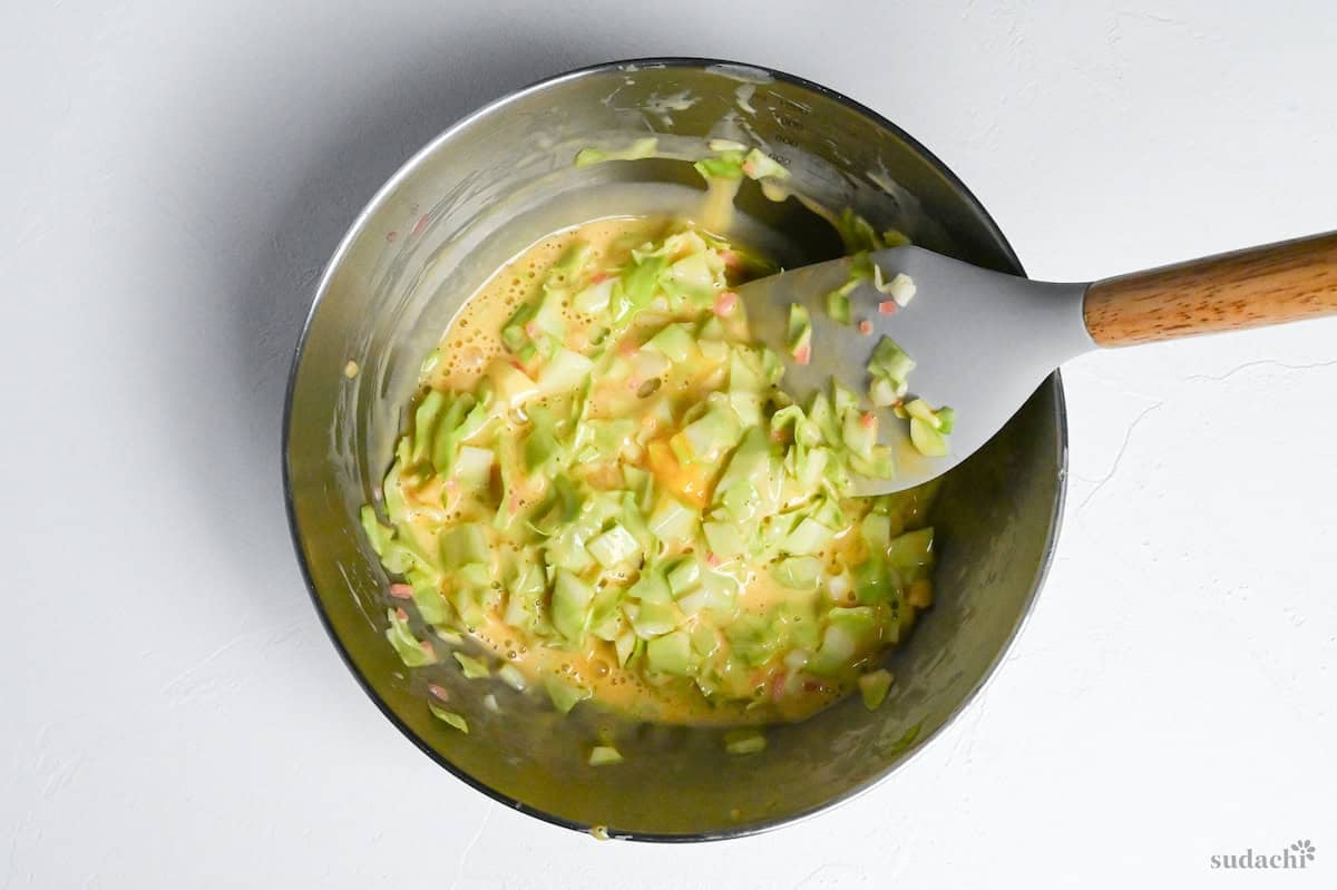 okonomiyaki batter mixed in a bowl on a white background