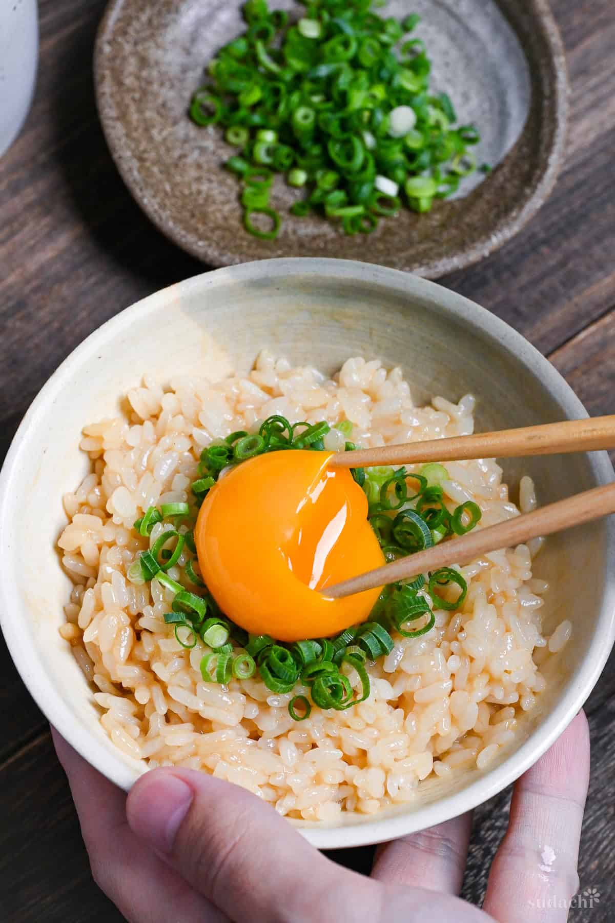 Breaking the egg yolk with chopsticks (Tamago Kake Gohan)
