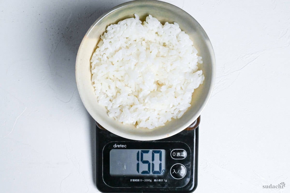 150g of cooked rice in a Japanese rice bowl on a digital scale