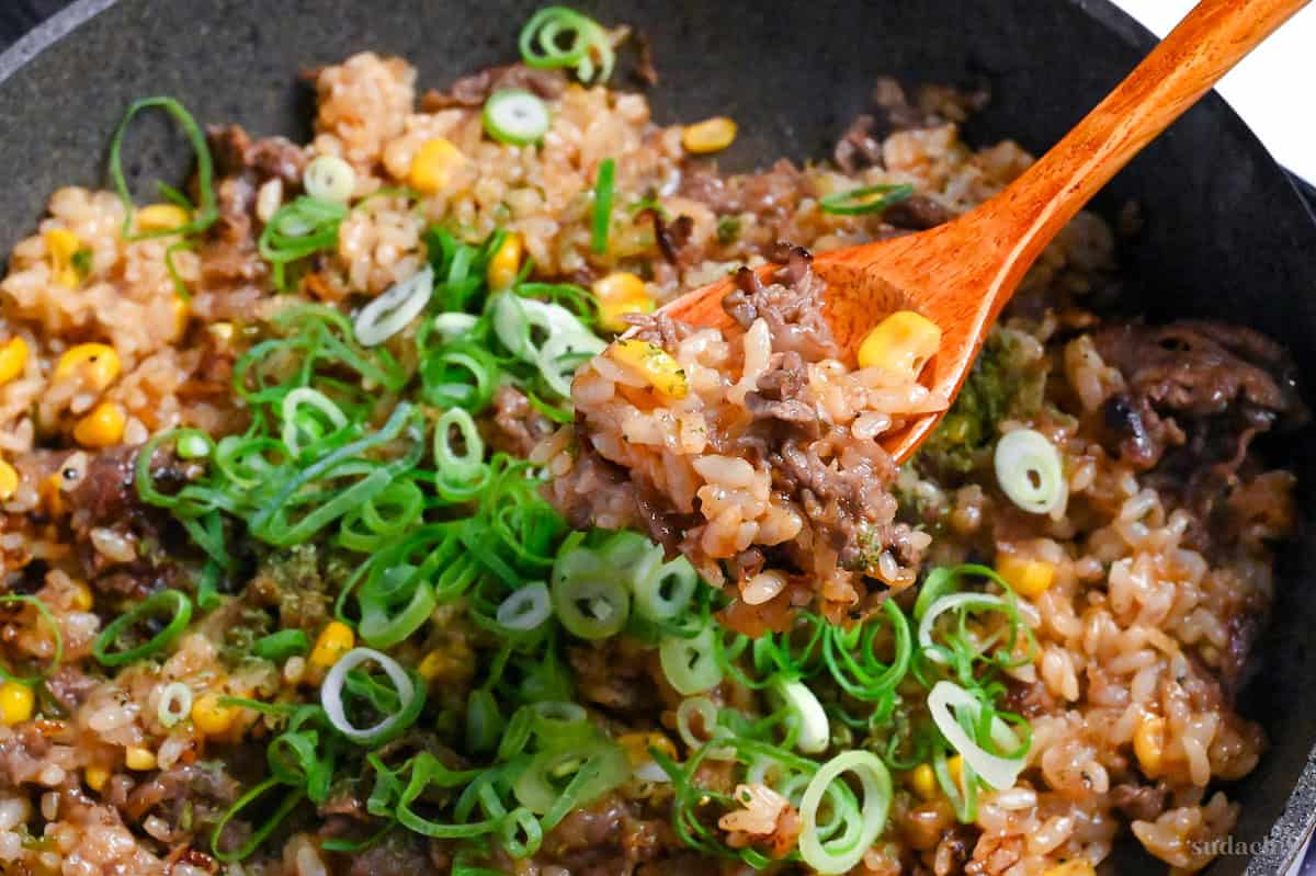 close up of Japanese beef pepper rice on a wooden spoon