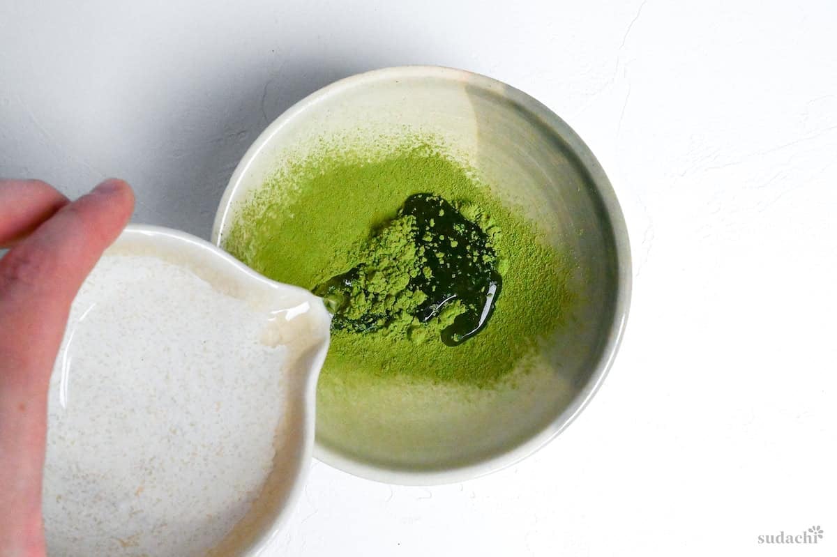 pouring water into sifted matcha
