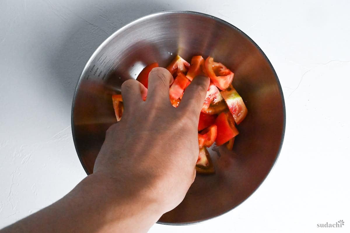 salted tomato in a mixing bowl