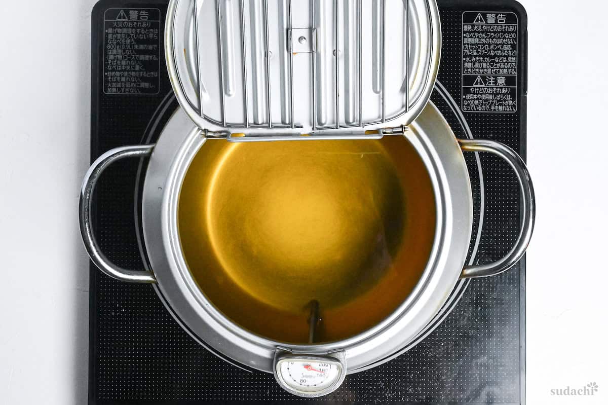 oil heated to 170 degrees in a Japanese style frying pot on the stovetop