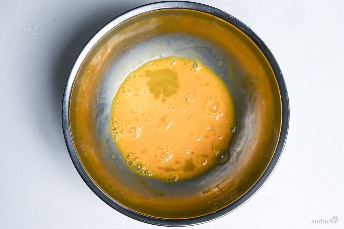 whisked egg in a mixing bowl