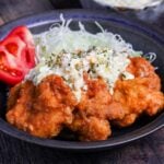 final plating of chicken nanban with shredded cabbage, tomato wedges and tartar sauce