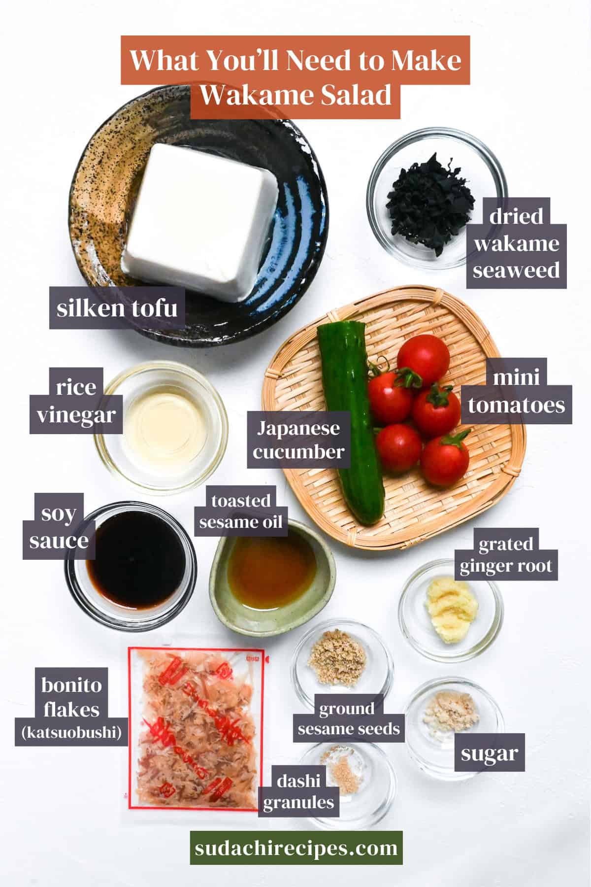 Ingredients needed to make wakame salad on a white background with labels. From top to bottom, left to right: silken tofu, dried wakame seaweed, rice vinegar, Japanese cucumber, mini tomatoes, soy sauce, toasted sesame oil, grated ginger, bonito flakes, ground sesame seeds, sugar, dashi granules
