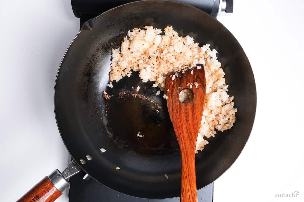 sauce added to side of pan to mix in with garlic fried rice