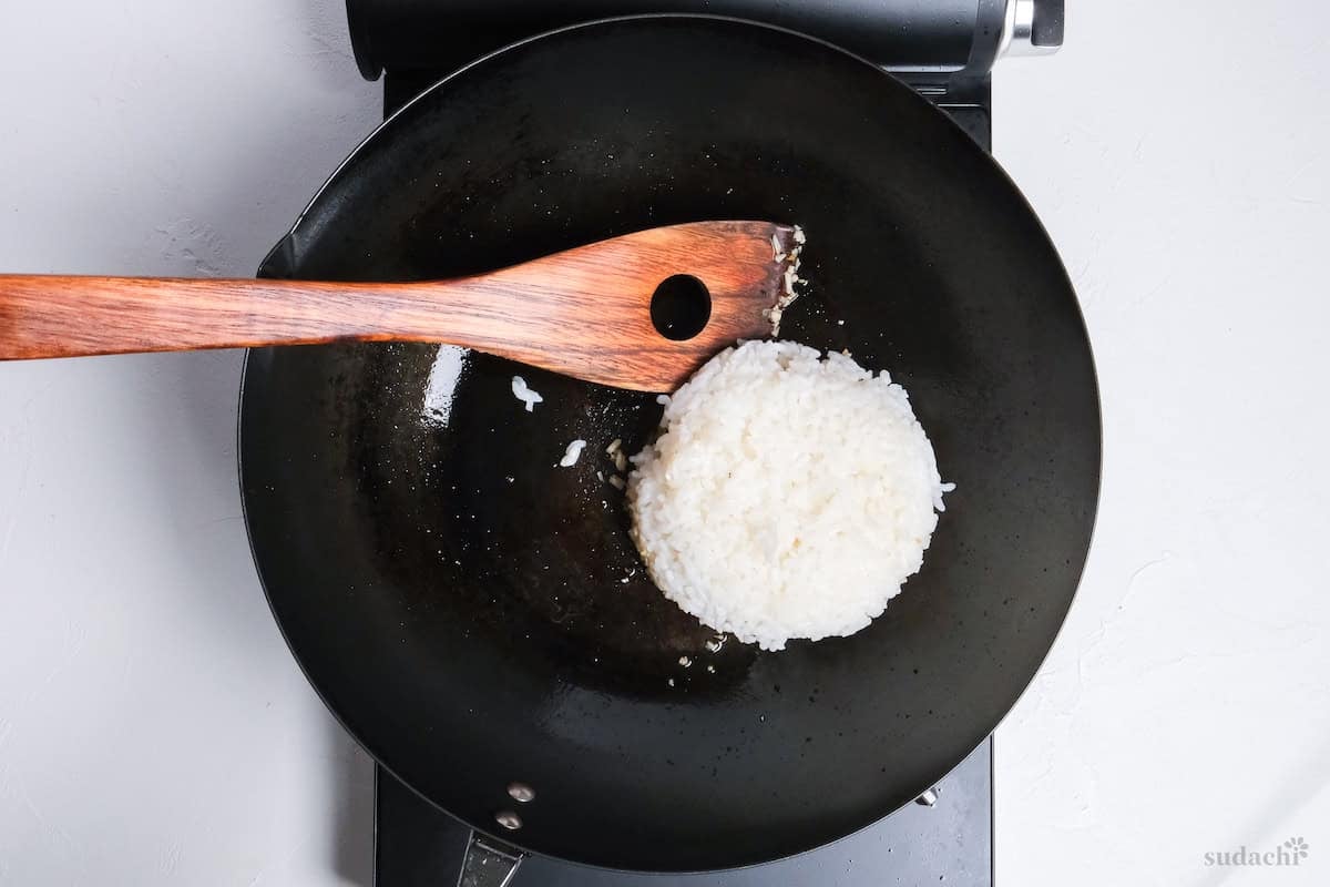 cooked rice in a wok to make fried rice