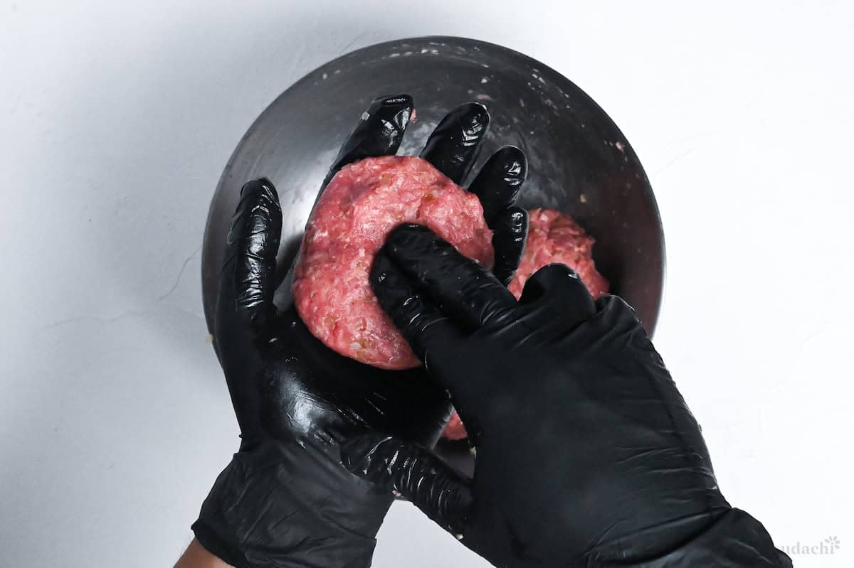 pressing a dent in the center of the hamburg patties