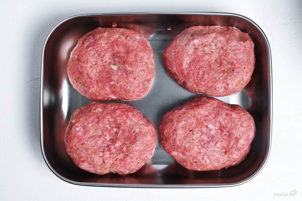 4 hamburg patties in a container
