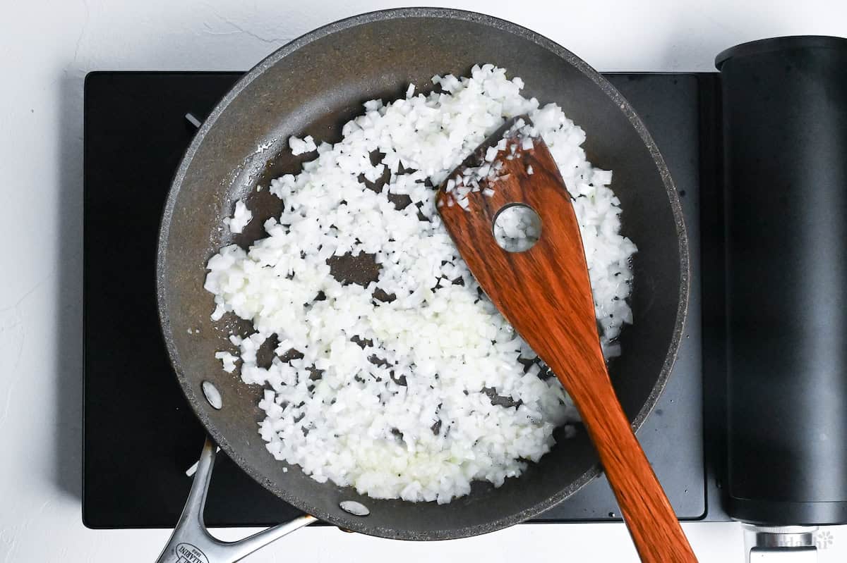 frying finely diced onion in a pan