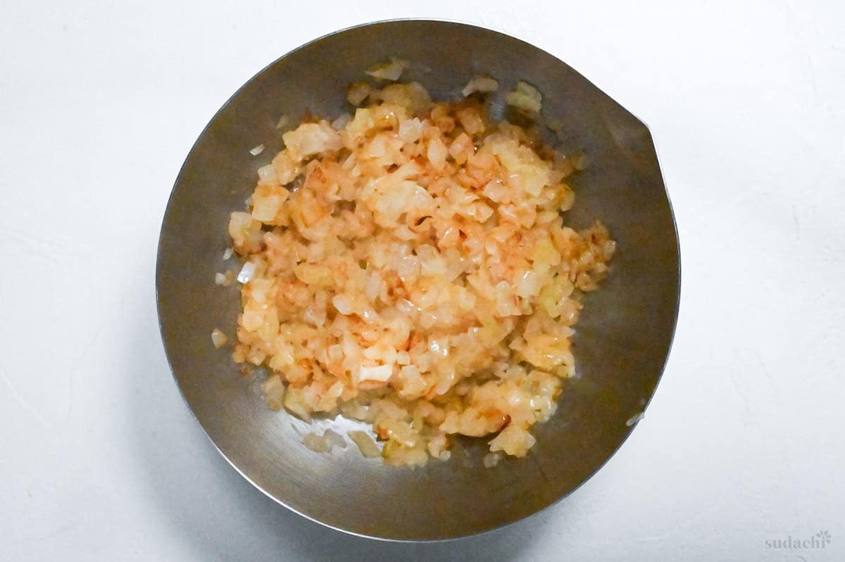 lightly golden finely diced onion in a steel mixing bowl