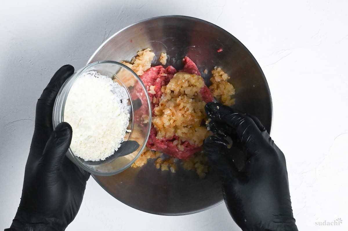 adding onions and milk/panko to ground meat in a bowl
