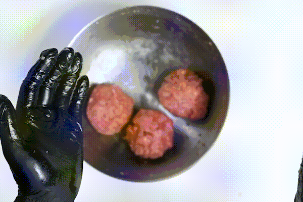 a gif showing how to throw a hamburg patty to remove excess air