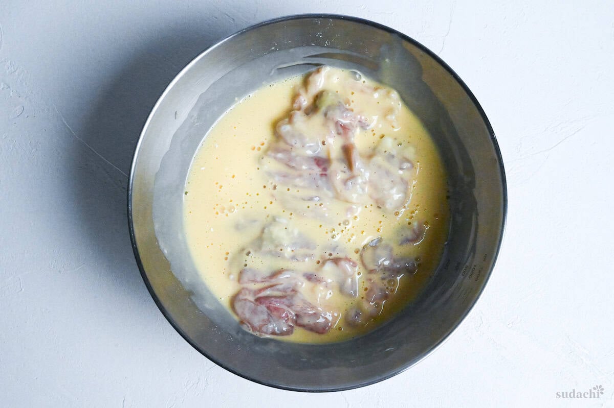 chicken in batter in a mixing bowl