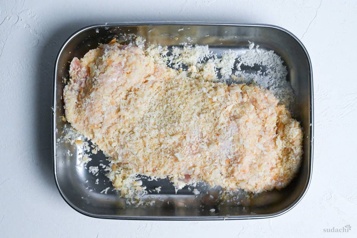 chicken coated with panko in a steel tray