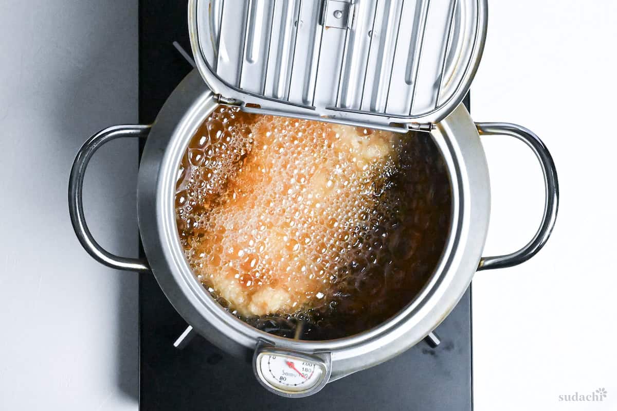 chicken katsu frying in a Japanese tempura frying pot