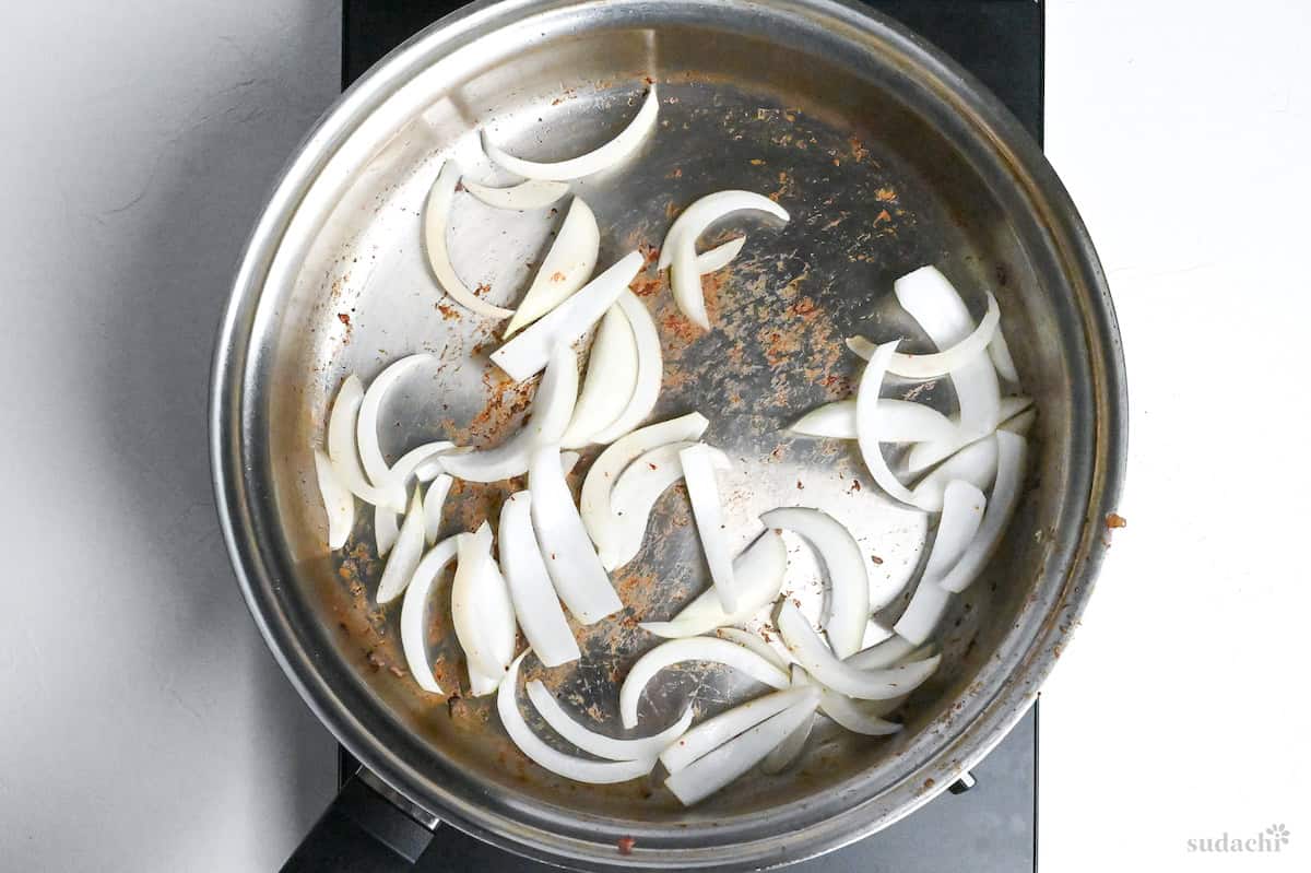 sliced onions in a frying pan