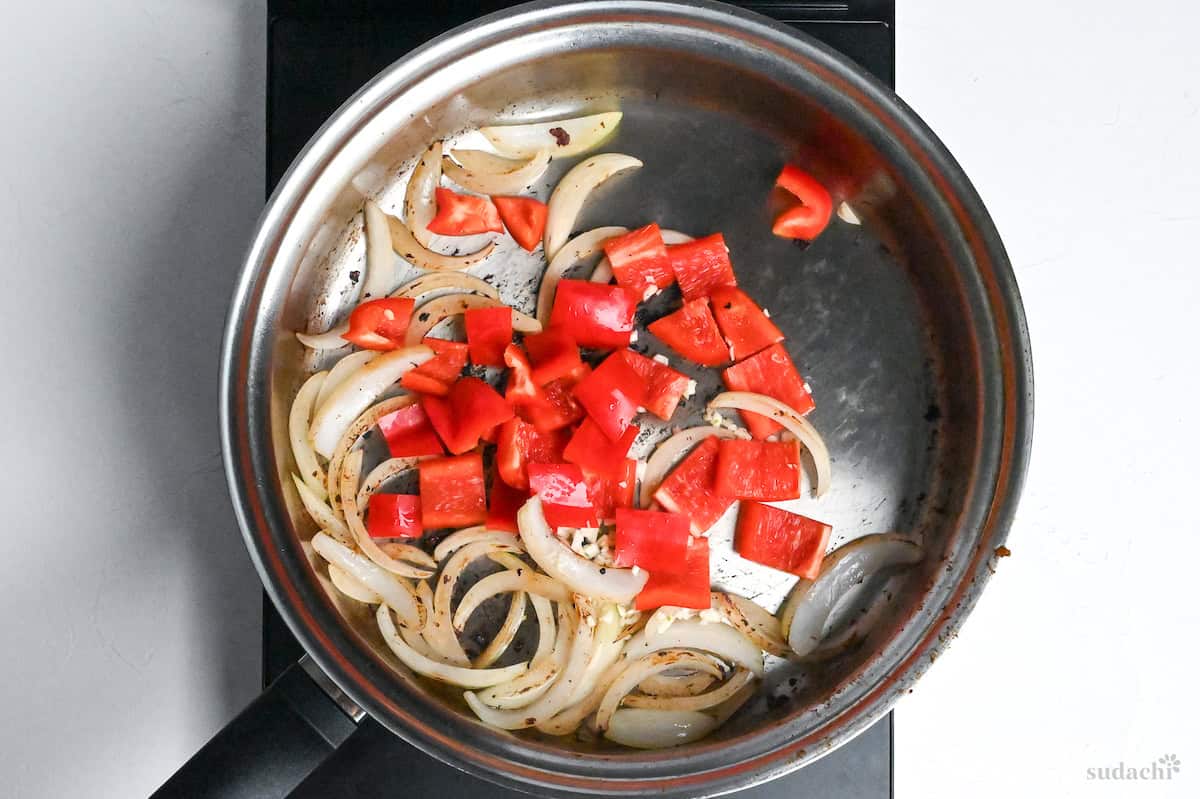 bell pepper and browned onions in a frying pan
