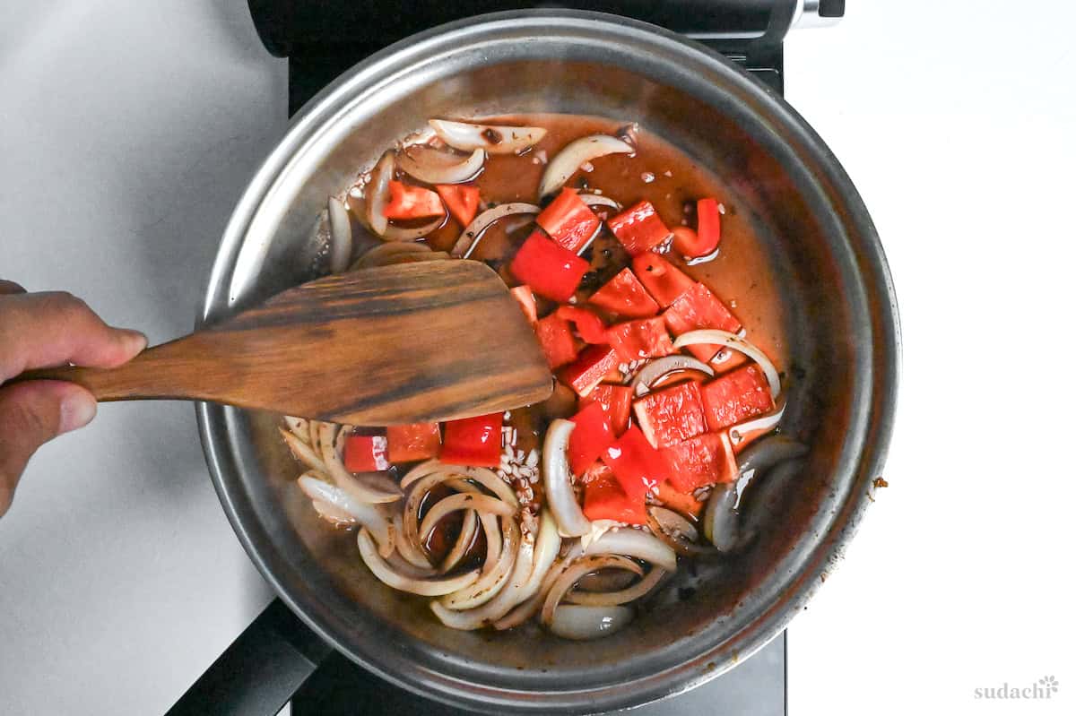 deglazing pan with onion and bell peppers