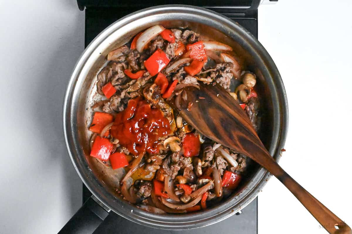 ketchup added to pan with beef and vegetables to make hayashi rice