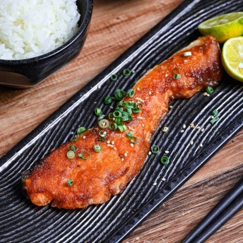 Miso glazed salmon on a long rectangular black plate with a wave design thumbnail