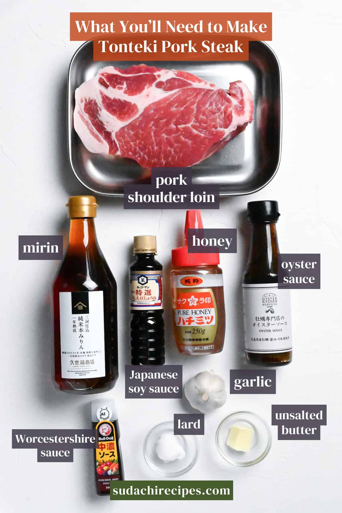 Ingredients needed to make Japanese Tonteki pork steak on a white background with labels. From top to bottom, left to right: pork shoulder loin, mirin, honey, oyster sauce, Japanese soy sauce, garlic, Worcestershire sauce, lard, unsalted butter