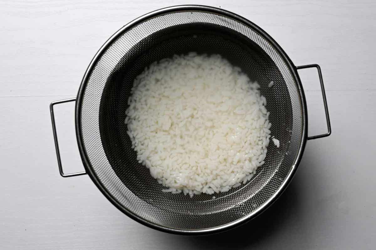 washing rice in a bowl of cold water
