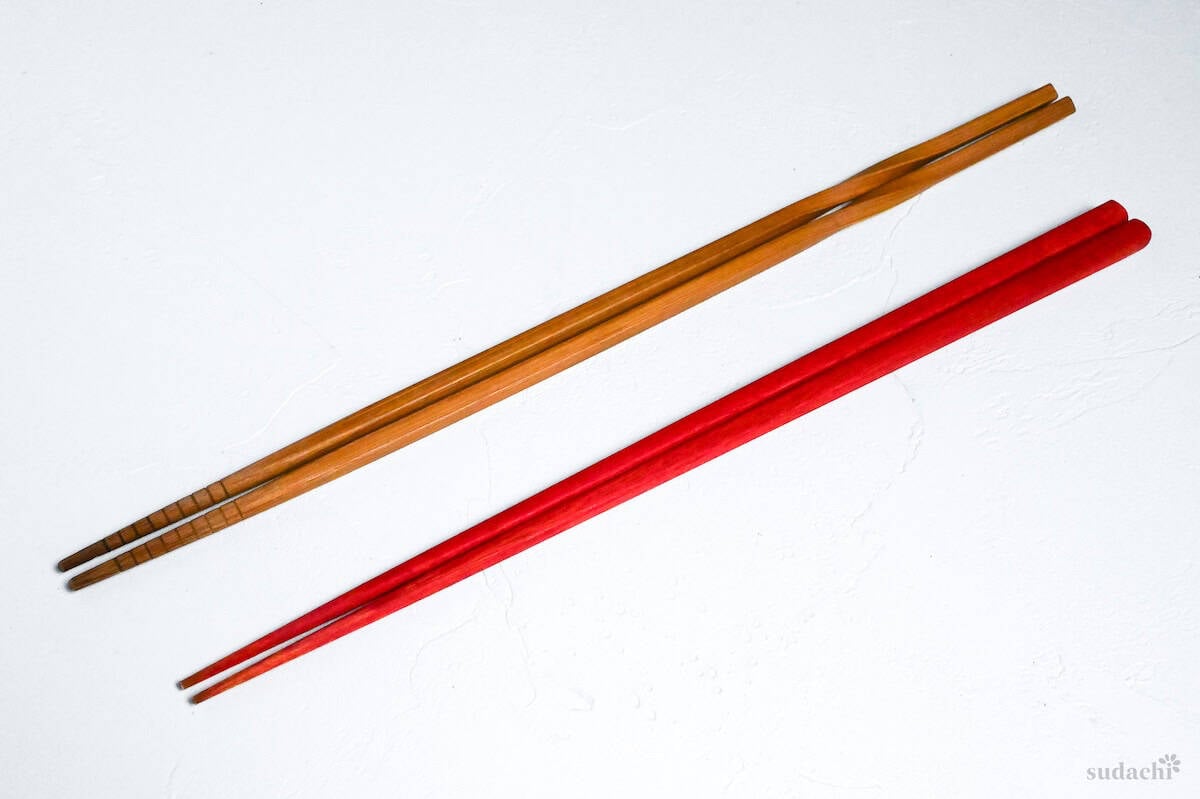 wooden and red cooking chopsticks on a white background