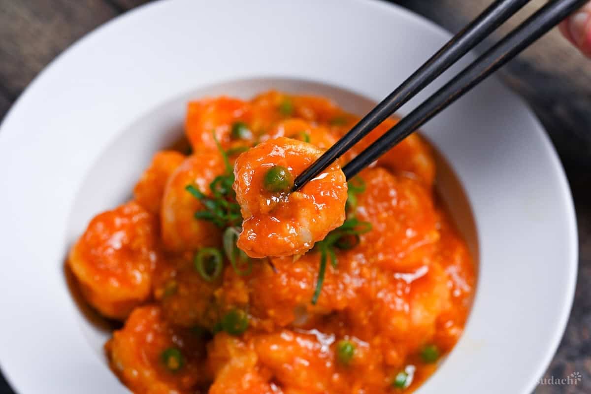 ebi chili held with black chopsticks